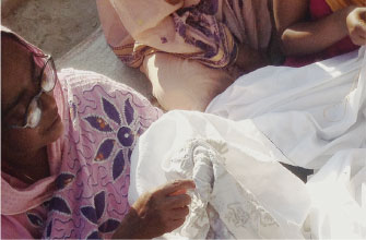 Two women working on some cloth